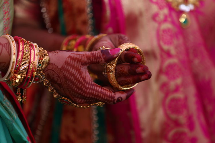 Woman wearing bangle to bride