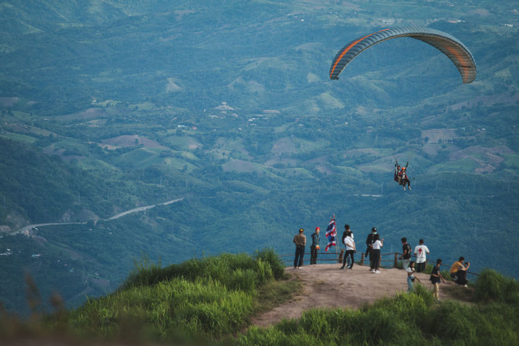 People flying by mountain