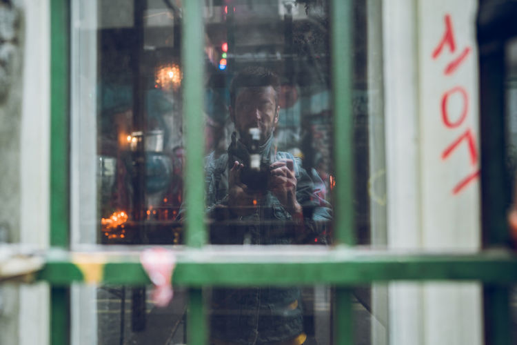 Reflection of man on glass window