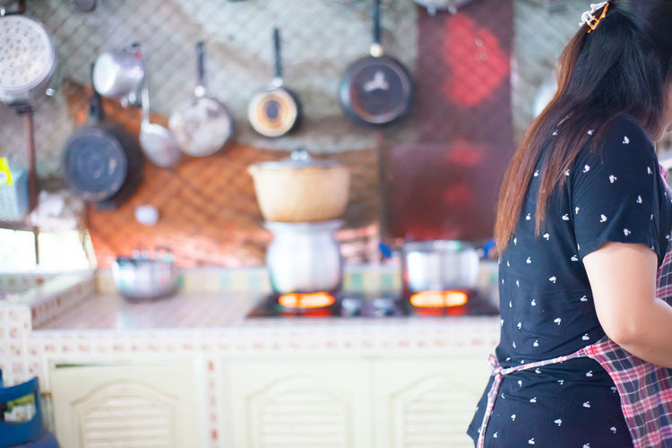Midsection of woman working in kitchen