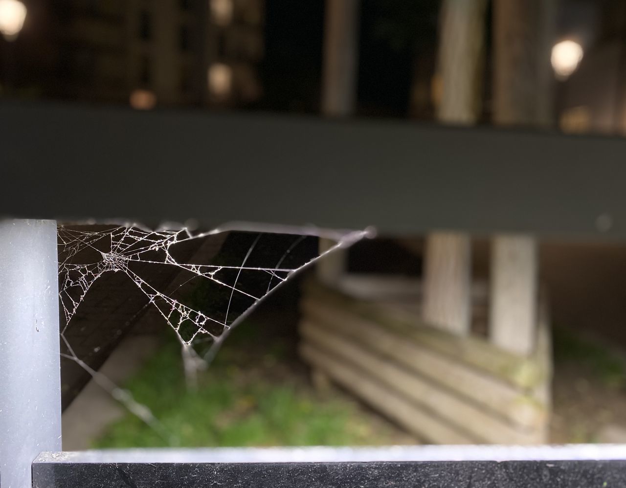 focus on foreground, light, no people, architecture, black, lighting, close-up, outdoors, nature, white, built structure, day, iron, spider web, fence