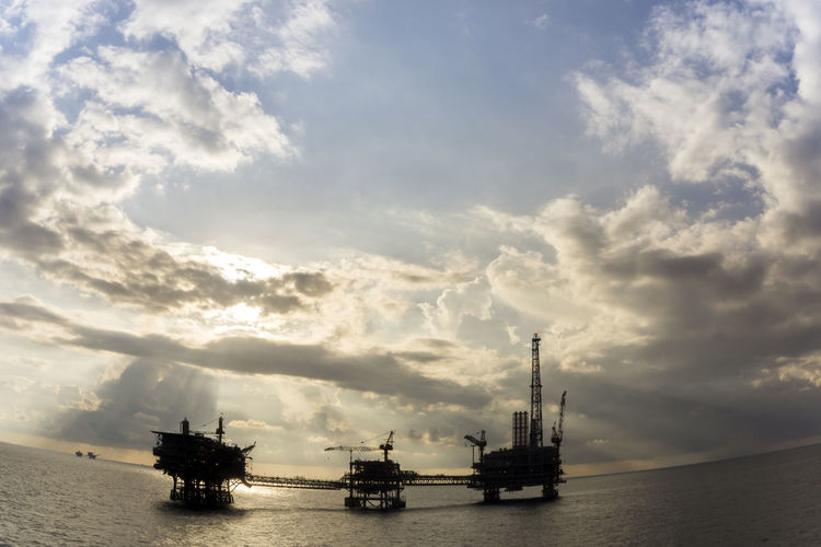 Silhouette of an oil production platforms during sunset at offshore terengganu oil field