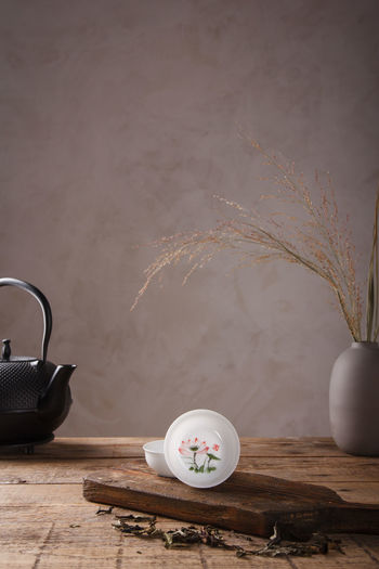 View of tea cup on table against wall
