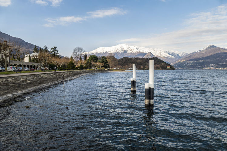 The lakeside promenade of colico with the snow-capped alps in the background