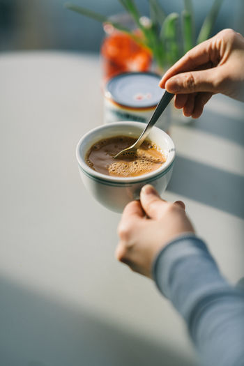 Close-up of hands holding coffee cup