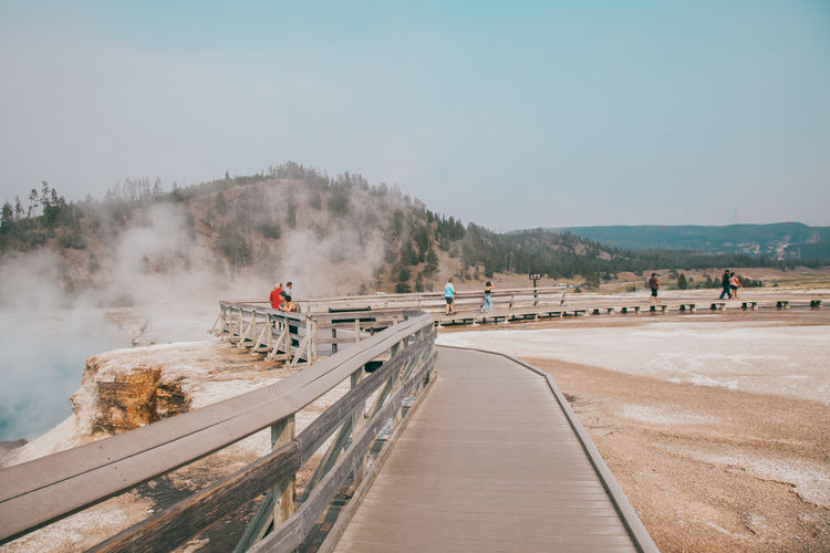 Wooden flooring for tourists in valley of geysers in yellowstone national park.
