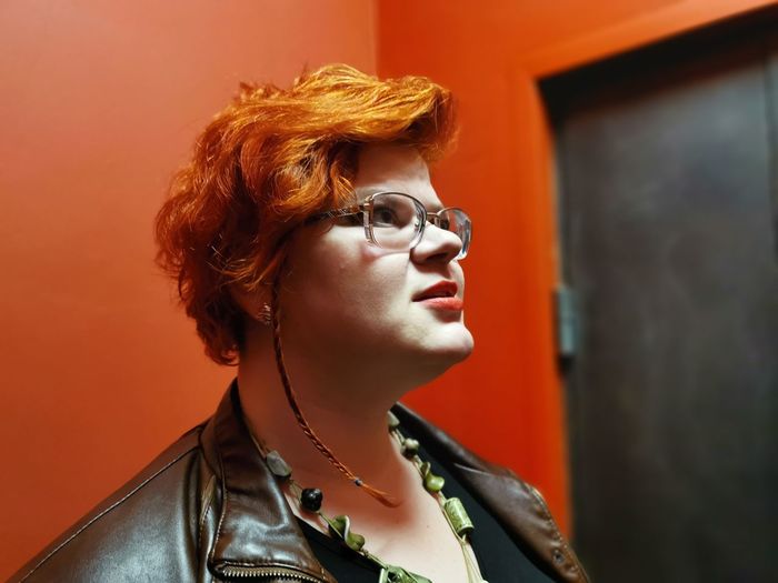 Redhead woman looking away at home