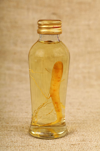 Close-up of ginseng in glass bottle