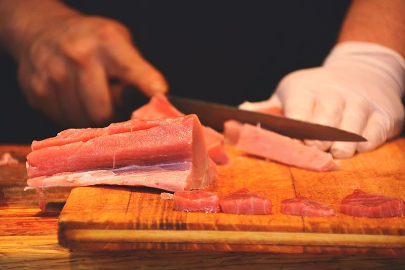Close-up of person cutting meat