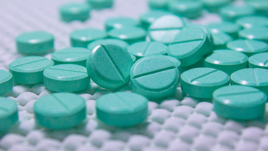 Close-up of green pills