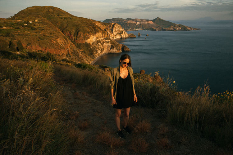 Full length of woman standing against landscape