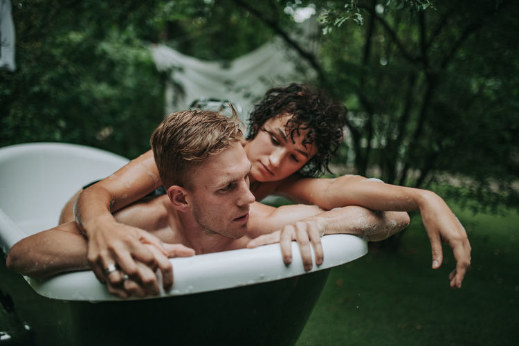 Couple in bathtub outdoors
