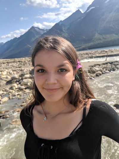 Portrait of smiling young woman in mountains
