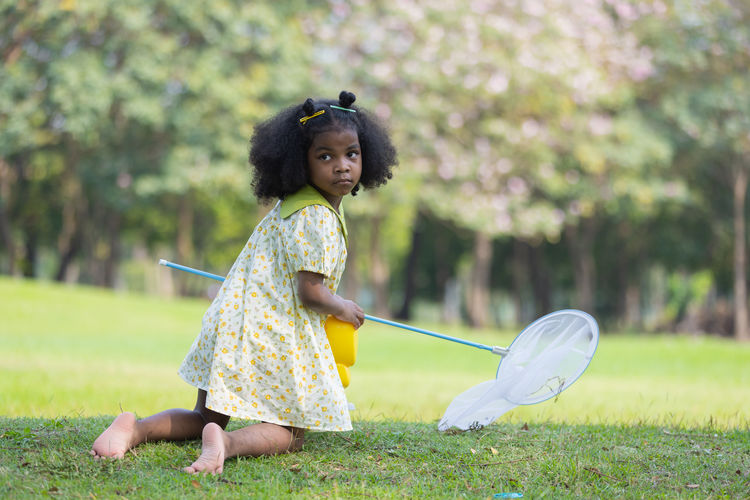 Side view of young woman standing in park