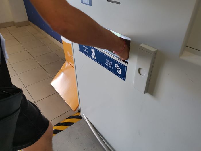 Cropped image of man using atm