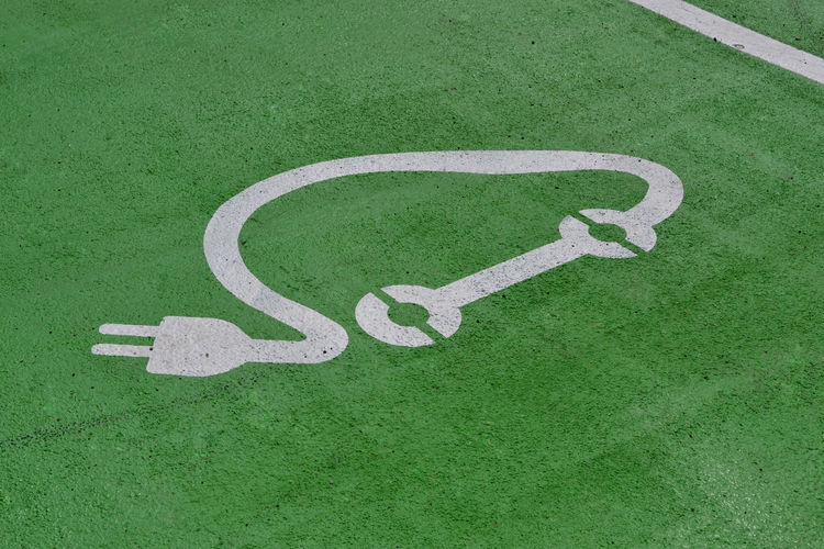 High angle view of symbol on green road