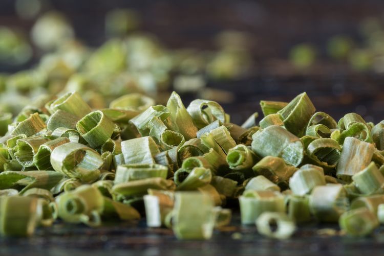 Close-up of dried chopped chive on table
