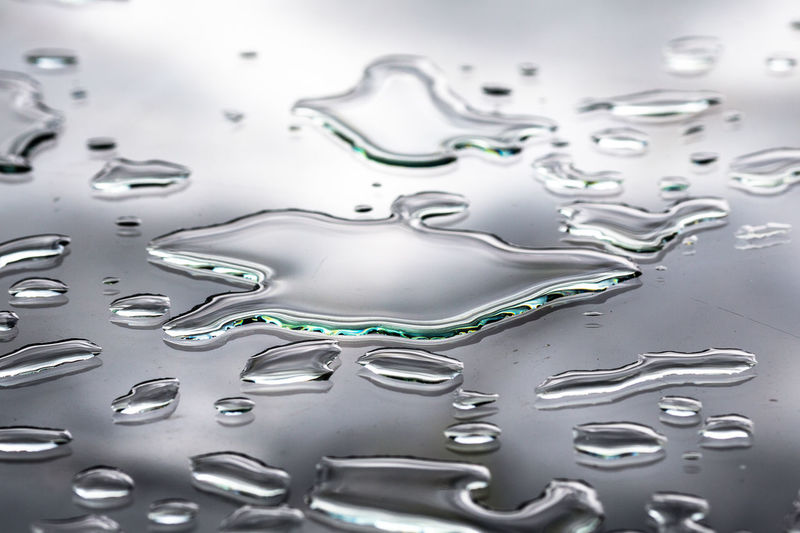 Close-up of spilled water on glass table