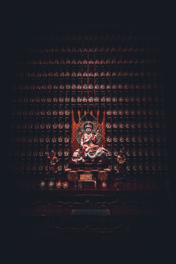 Statue of illuminated building in temple