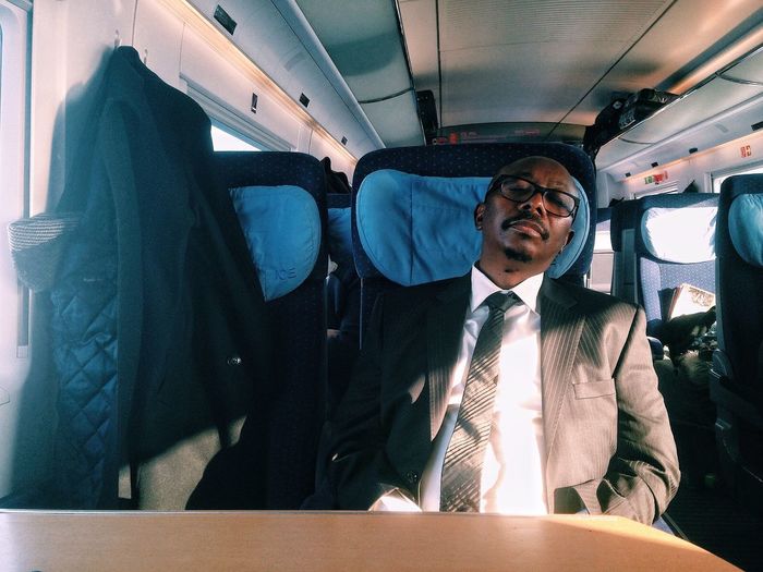 Businessman sleeping while traveling in train