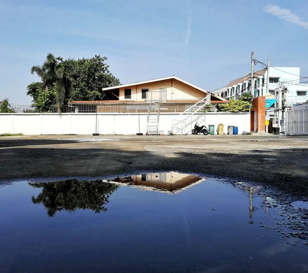 Reflection of trees and buildings in canal