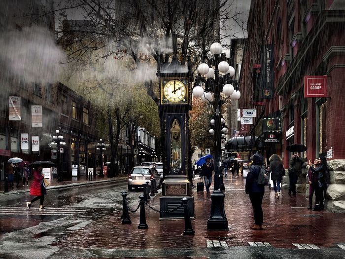 People walking on wet road in rainy season