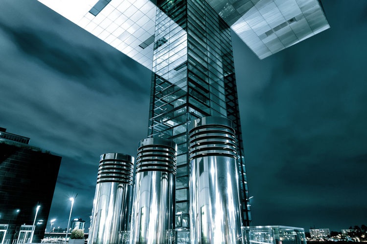 Low angle view of illuminated skyscraper against sky at night