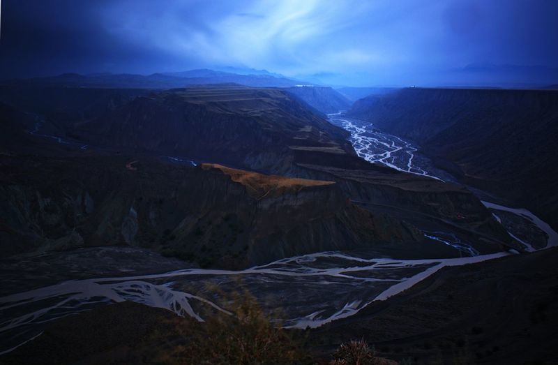 Scenic view of river amidst canyon against sky