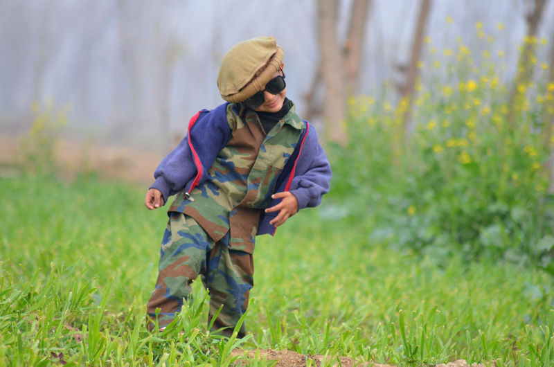 Rear view of man standing on field