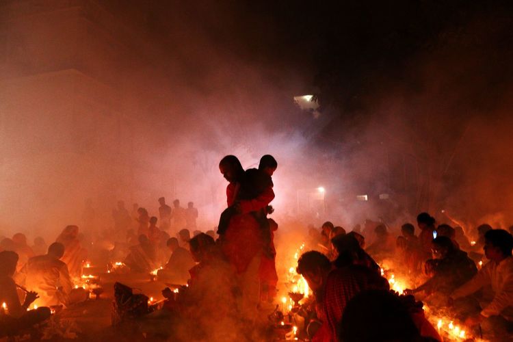 People are praying at rakher upobash in a smokey environment
