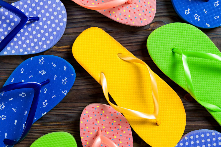 Top view of flip flops on colored background 