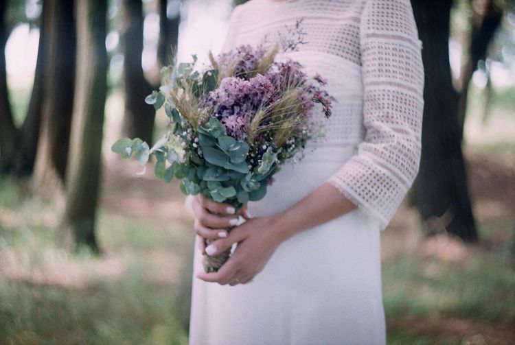 Midsection of woman holding bouquet