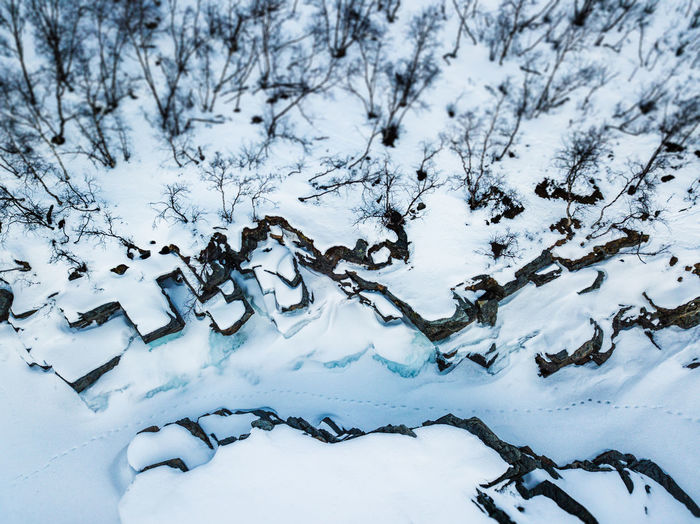 Aerial view of footsteps in the snow in a snow covered canyon