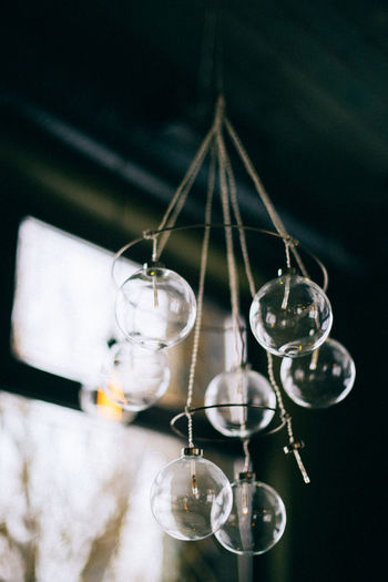 Close-up of light bulb hanging on ceiling