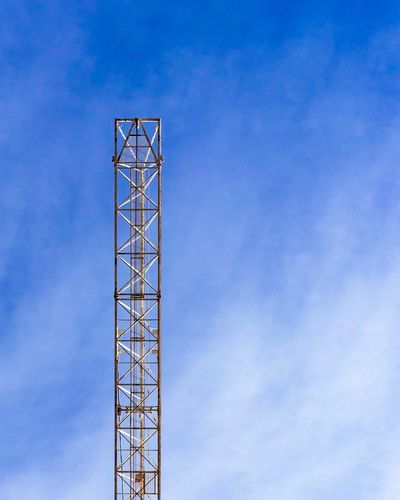 Low angle view of construction crane against blue sky