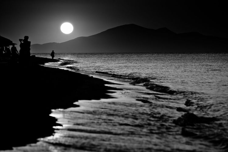 Scenic view of sea against clear sky at sunset