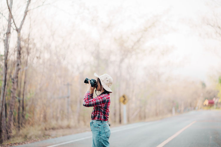 Rear view of woman standing on street