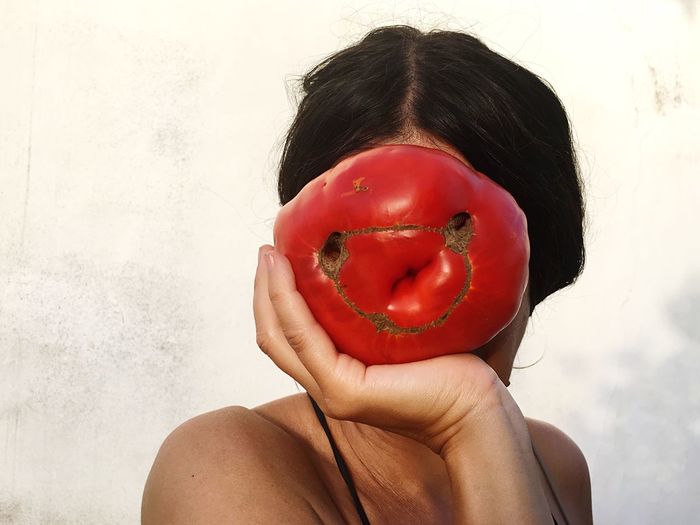 Close-up of woman holding tomato