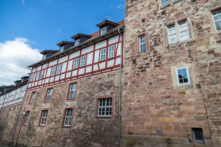 Facades of historic half-timbered houses and city wall in wasungen, thuringia