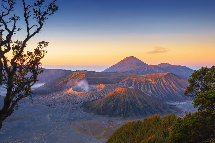 Scenic view of snowcapped mountains against sky during sunset