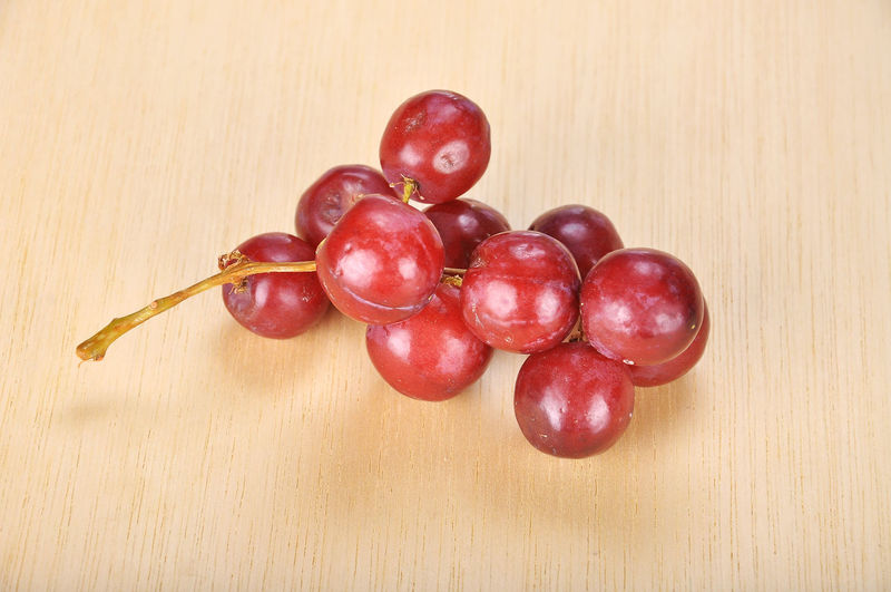 Close-up of red grapes on table