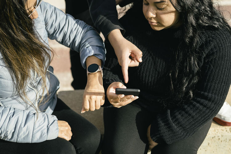 Midsection of woman using mobile phone