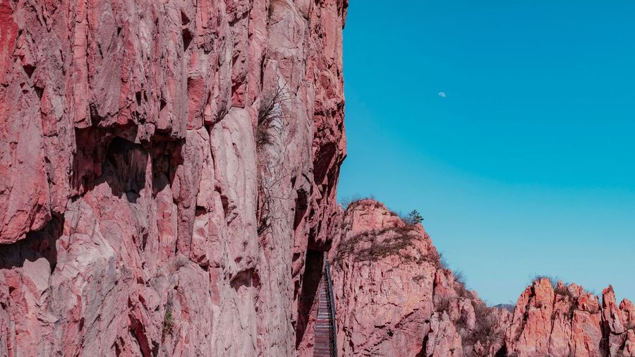 Low angle view of pink rock formation against sky