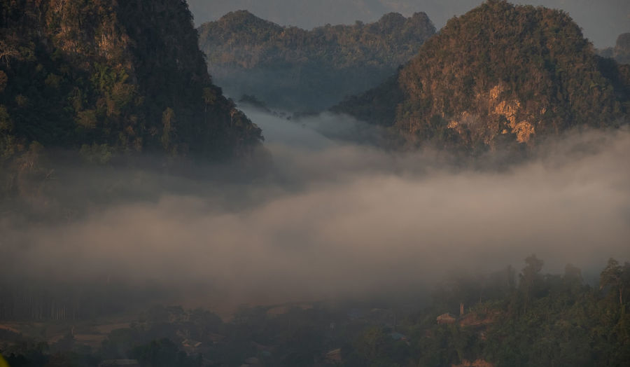 Scenic view of fog with mountains