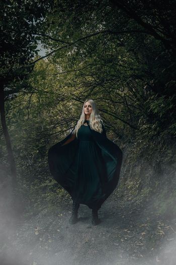 Woman dressed as a witch in a forest
