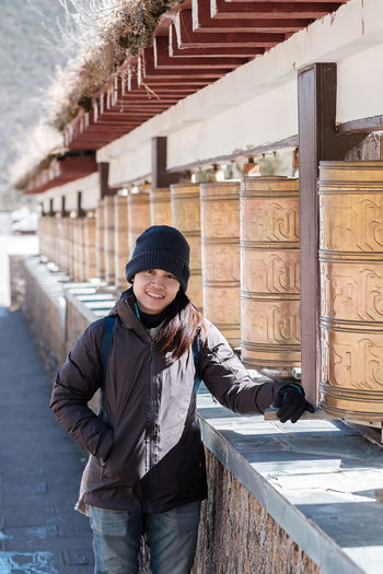 Portrait of woman standing in temple during winter