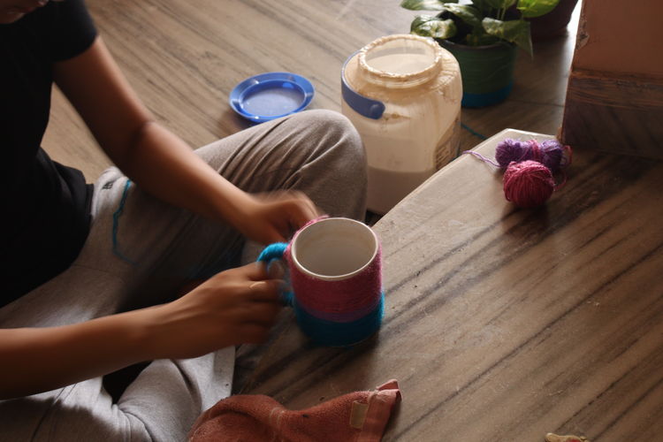 Midsection of woman holding drink on table diy at home
