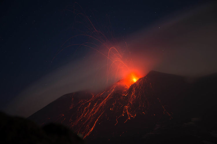 Etna volcano eruption with lava explosion in the night - sicily 