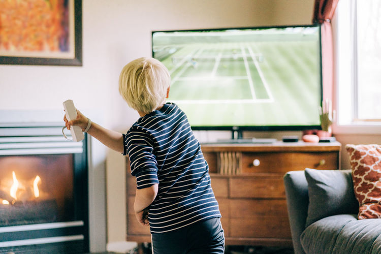 Young boy playing video games on tv