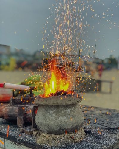 Close-up of burning fire against sky